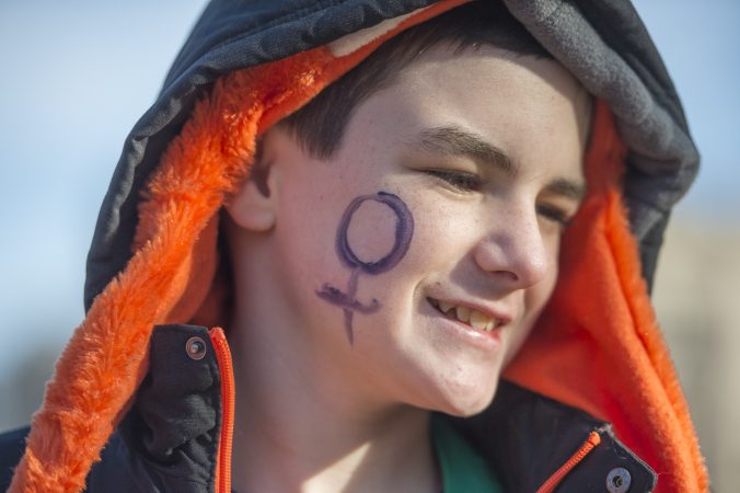 Tyler Zordan, 12, sports a women's logo on his cheek. (Jonathan Wilson for WHYY)
