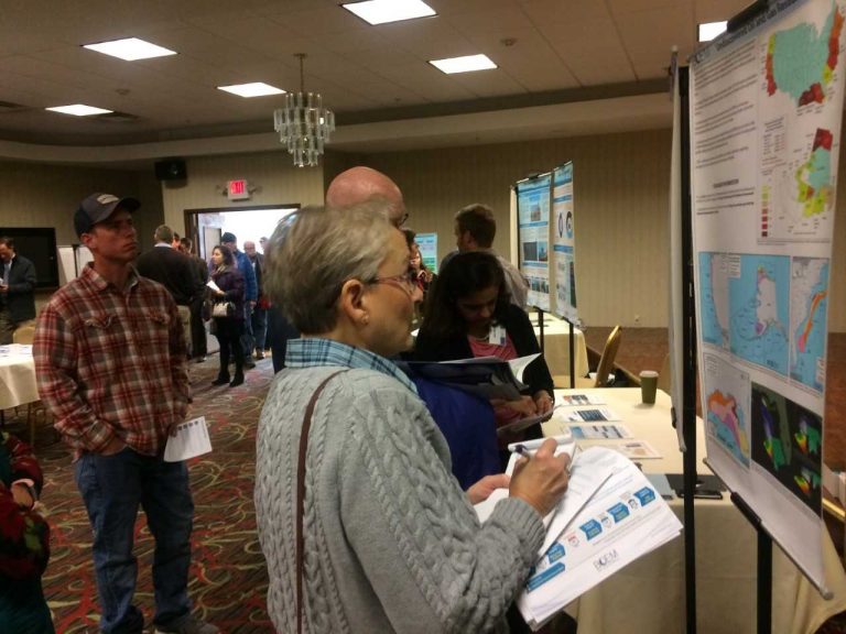 At a public information session in Dover, Delaware, Thursday, Charlotte Reid looks over information about the Trump administration's plan to expand oil and gas drilling along the Atlantic coastline. She fears that could put Delaware at risk of a spill.