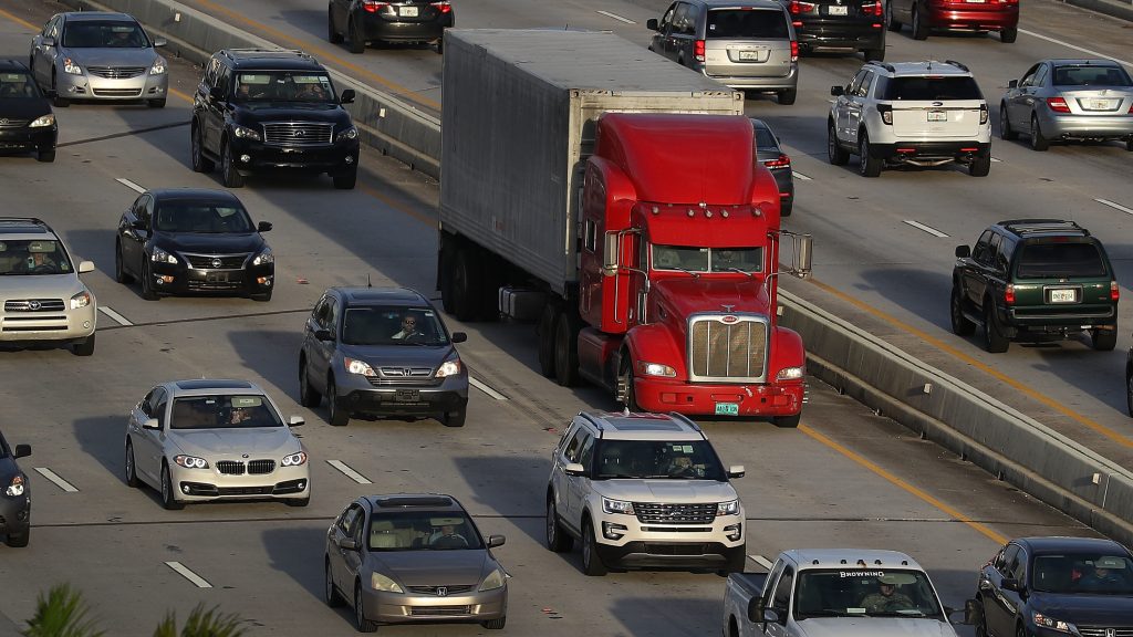 A tractor-trailer rolls along the highway in Miami last November. The trucking industry needs to hire almost 900,000 more drivers in order to meet rising demand, according to an industry analysis. A tractor-trailer rolls along the highway in Miami last November. The trucking industry needs to hire almost 900,000 more drivers in order to meet rising demand, according to an industry analysis. (Joe Raedle/Getty Images)