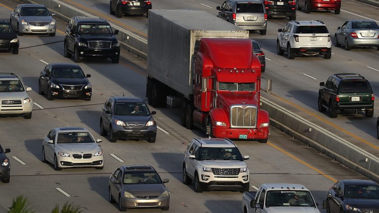A tractor-trailer rolls along the highway in Miami last November. The trucking industry needs to hire almost 900,000 more drivers in order to meet rising demand, according to an industry analysis. (Joe Raedle/Getty Images)