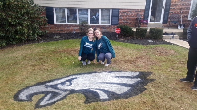 Lauren Bruton and Erin Lynch helped stencil 10 lawns with the Eagles logo in their neighborhood in Delaware County, south of Philadelphia. (Courtesy of Paul Bruton)