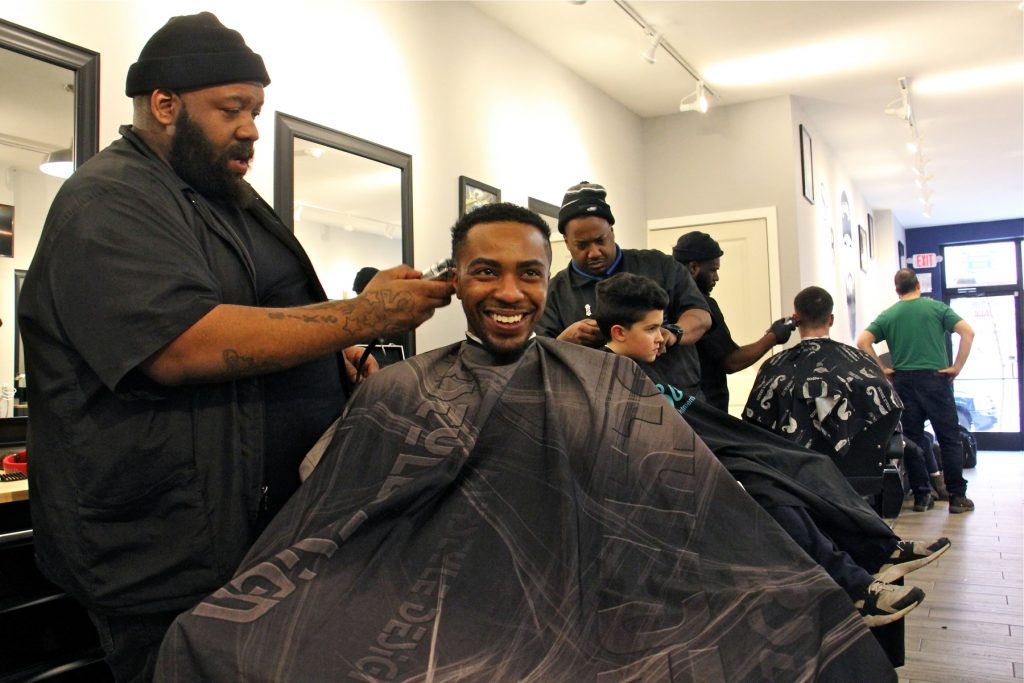 2018 02 02-e lee-mike jordan mark belle-philadelphia south street barbers Mike Jordan (left) and Mark Belle chat at South Street Barbers. (Emma Lee/WHYY)