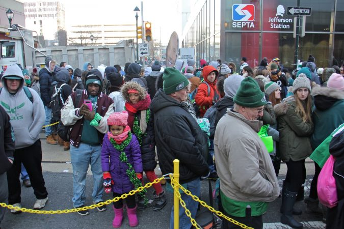 Regional rail users wait in lines that stretch for blocks after the Super Bowl parade. (Emma Lee/WHYY)