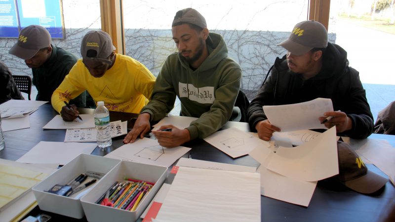 Members of the Mural Arts Guild, a paid apprenticeship program for former inmates, participate in a paint session at the Mural Arts Studio at the Barnes. (Emma Lee/WHYY)
