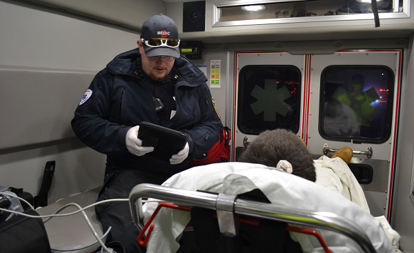 Susquehanna Township EMS Captain Dan Tempel collects information from a man who he just revived from a drug overdose. (Brett Sholtis/Transforming Health)