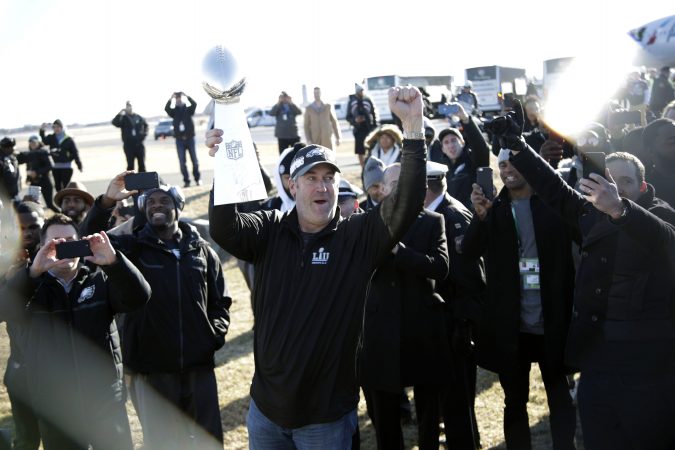 Eagles head coach Doug Pederson holds up the Vince Lombardi Trophy while displaying it to fans gathered to welcome them in Philadelphia a day after defeating the New England Patriots in Super Bowl 52 in Minneapolis, Monday, Feb. 5, 2018. (AP Photo/Julio Cortez)