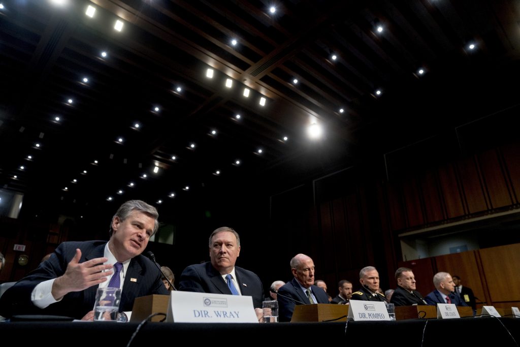 Dan Coats, Mike Pompeo, Michael Rogers, Christopher Wray, Robert Ashley, Robert Cardillo (From left) FBI Director Christopher Wray, accompanied by CIA Director Mike Pompeo, Director of National Intelligence Dan Coats, Defense Intelligence Agency Director Robert Ashley, National Security Agency Director Adm. Michael Rogers, and National Geospatial-Intelligence Agency Director Robert Cardillo, speaks at a Senate Select Committee on Intelligence hearing on worldwide threats, Tuesday, Feb. 13, 2018, in Washington. (Andrew Harnik/AP Photo)
