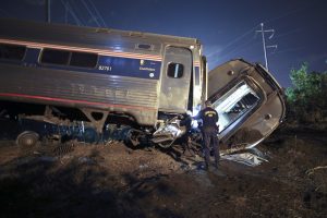 In this May 12, 2015, file photo, emergency personnel work the scene of a deadly train wreck in Philadelphia. An Amtrak train headed to New York City derailed and crashed in Philadelphia. (AP Photo/ Joseph Kaczmarek, File)