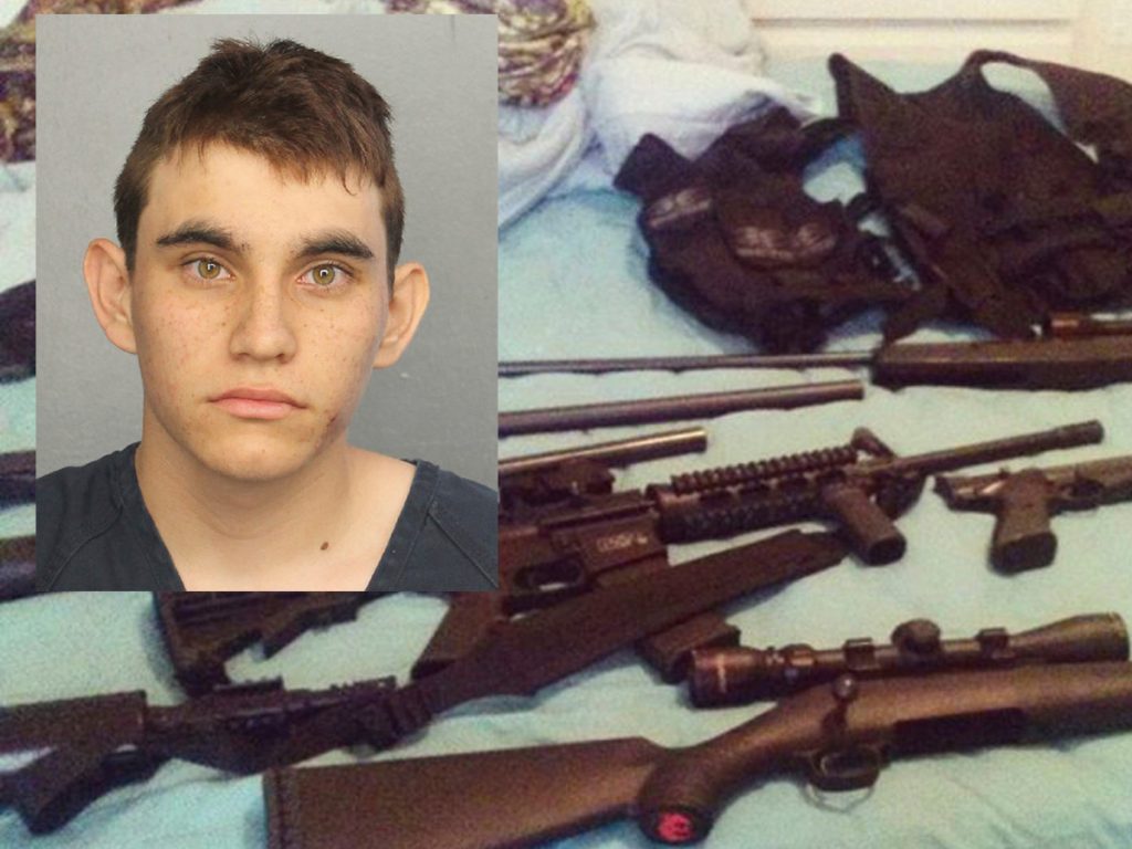 APfloridaschoolshootingx1200 Nikolas Cruz pictured over a photo posted on his Instagram account which shows weapons lying on a bed. Cruz was charged with 17 counts of premeditated murder on Thursday, Feb. 15, 2018, the day after opening fire with a semi-automatic weapon in the Marjory Stoneman Douglas High School in Parkland, Fla. (Broward County Jail and Instagram via AP)