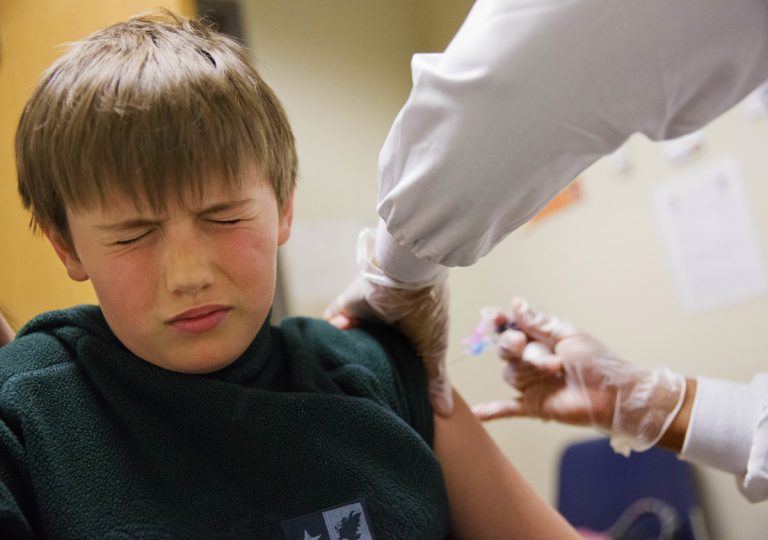 Reed Olson, 8, gets a flu shot, Monday, Feb. 5, 2018. The U.S. government's latest flu report released on Friday, Feb. 2, 2018, showed flu season continued to intensify the previous week, with high volumes of flu-related patient traffic in 42 states, up from 39 the week before. (David Goldman/AP Photo)