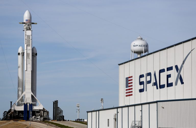 A Falcon 9 SpaceX heavy rocket stands ready for launch on pad 39A at the Kennedy Space Center in Cape Canaveral, Fla., Monday, Feb. 5, 2018. The Falcon Heavy scheduled to launch Tuesday afternoon, has three first-stage boosters, strapped together with 27 engines in all. (Terry Renna/AP Photo)