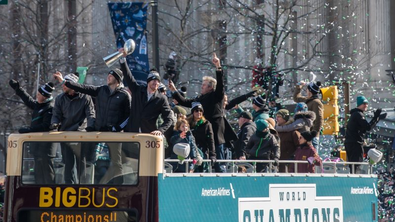 Philadelphia Eagles Players hold the Vince Lombardie Trophy during the teams celebratory parade through. (Branden Eastwood for WHYY)
