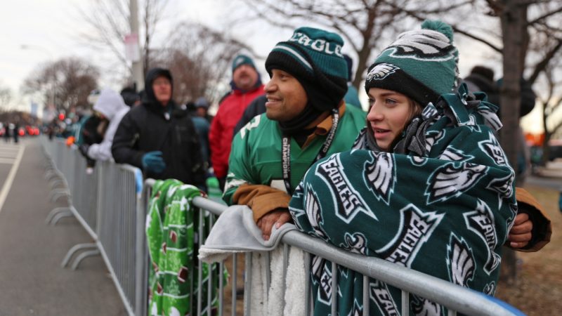 Juan Ramos and his niece, Kayla, from Allentown have been waiting for the parade since 4 a.m. He says the highlight of the Super Bowl was the Philly Special trick play for a touchdown. (Lindsay Lazarski/ WHYY)