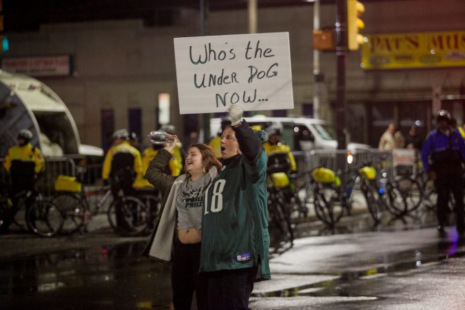 Eagles fans celebrate just before the end of regulation during Superbowl LII against the New England Patriots at Frankford and Cottman Avenue Sunday night. (Brad Larrison for WHYY)