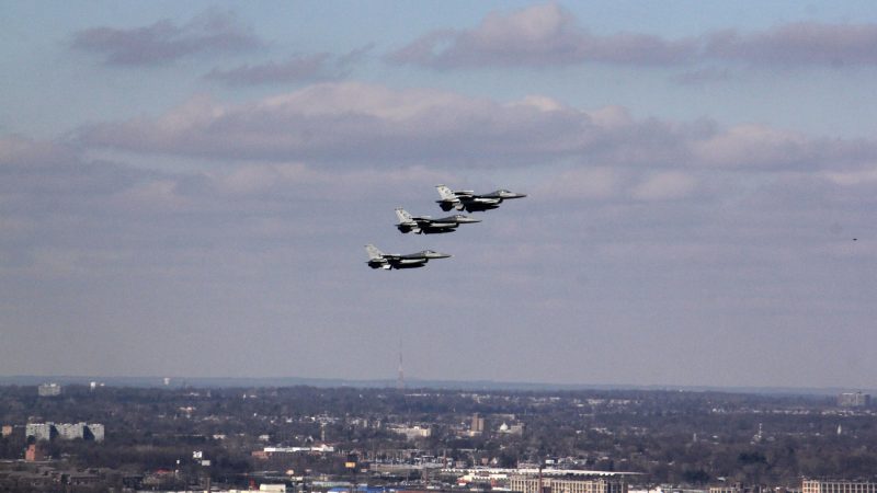 Three fighter jets soar above the Ben Franklin Parkway during the Eagles Super Bowl parade. (Emma Lee/WHYY)