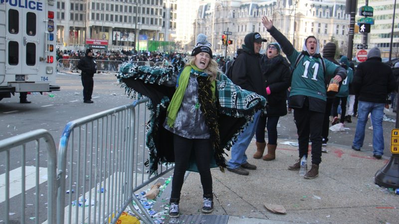 Long after the parade has passed, Brittany Robinson of Conshohocken screams her support for the Eagles. (Emma Lee/WHYY)