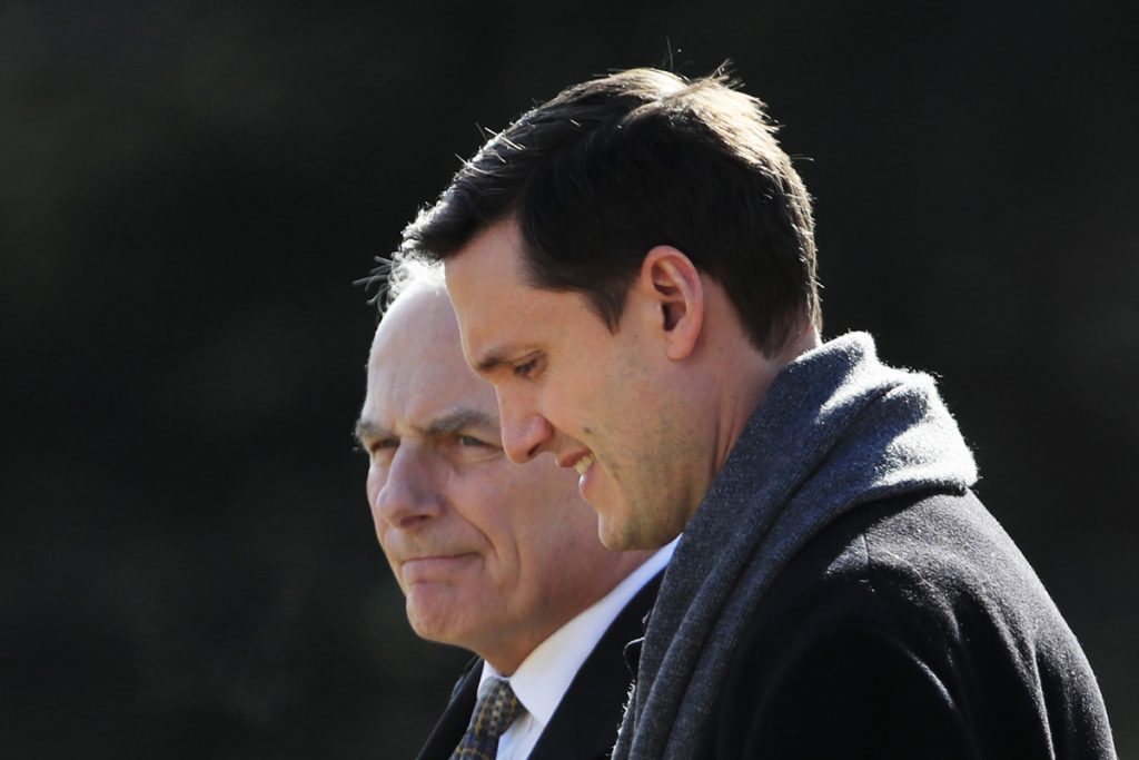 White House staff secretary Rob Porter, foreground, walks with White House Chief of Staff John Kelly, to board Marine One on the South Lawn as they leave the White House on Friday, Feb. 2, 2018.