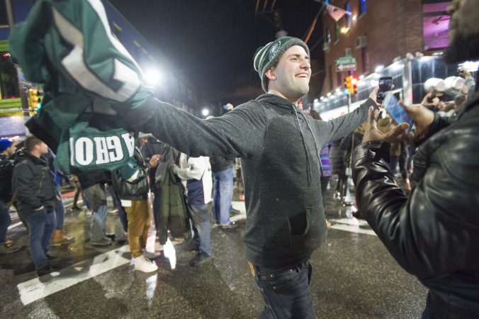 An Eagles fan walks along South St. towards Broad St.