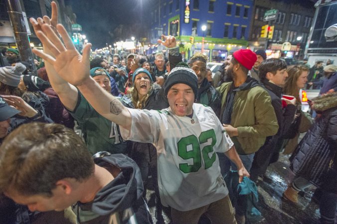 Eagles fans walk along South St. towards Broad St.
