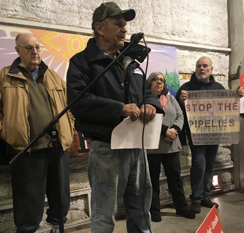 Unknown-e1517604062821 A landowner rips up an offer of compensation from PennEast at a rally February 2, 2018. (Jon Hurdle/StateImpact Pennsylvania)