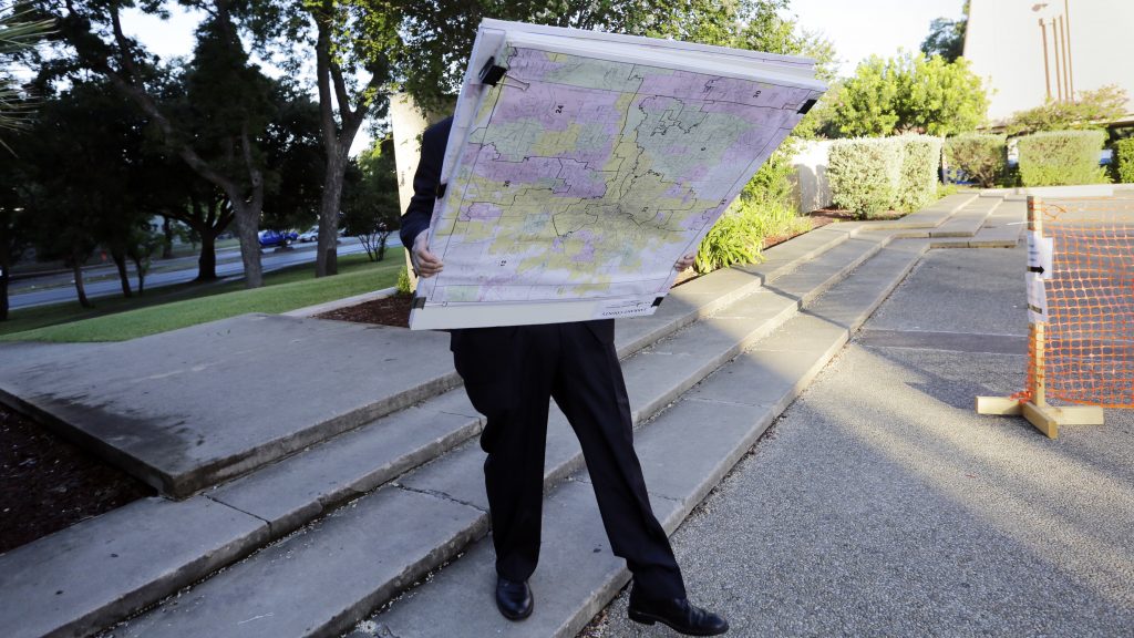 A man with a set of maps heads to a federal courthouse in San Antonio last year for a redistricting trial. Texas is one of three states with cases before the Supreme Court in redistricting. A man with a set of maps heads to a federal courthouse in San Antonio last year for a redistricting trial. Texas is one of three states with cases before the Supreme Court in redistricting. (Eric Gay/AP)