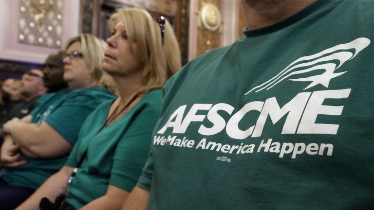 Members of the American Federation of State County and Municipal Employees union, or AFSCME, listen to a council executive speak about conditions at state prisons and detention centers in Illinois.