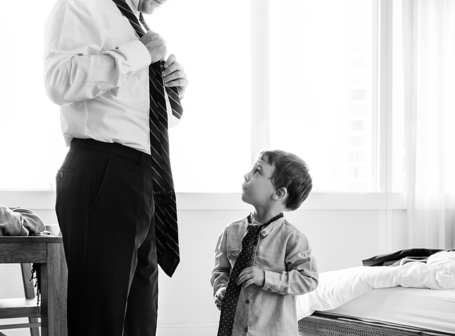 Father teaching the son how to tie a necktie Father teaching the son how to tie a necktie