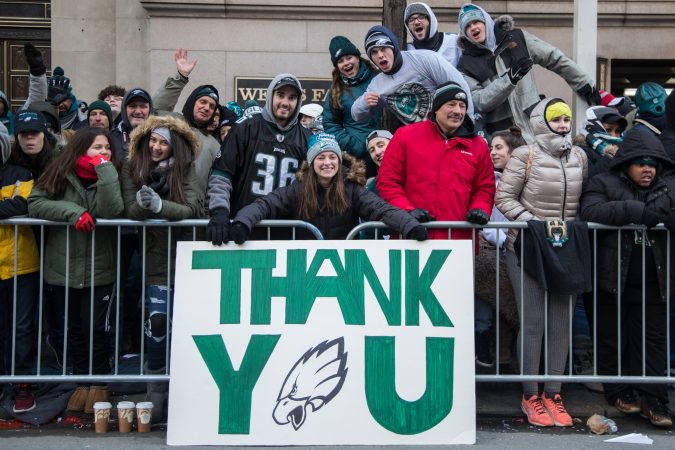 Alyssa Yates, 19, (center) holds her handmade sign at the Eagles Super Bowl Champions parade in Philadelphia February 8, 2018. (Emily Cohen for WHYY)
