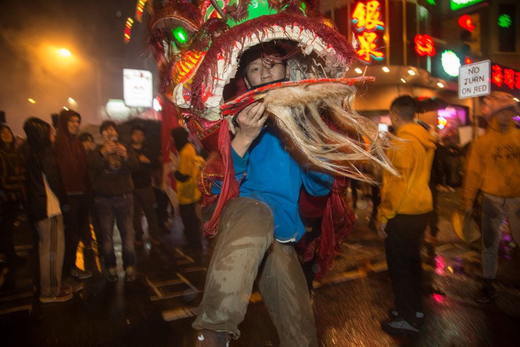 cohen-lion_dance-20 A member of the Philly Suns does a lion dance through the streets of Chinatown in celebration of the Chinese New Year on February 15th 2018. (Emily Cohen for WHYY)