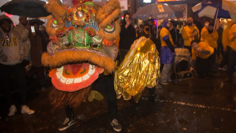 A member of the Philly Suns does a lion dance through the streets of Chinatown in celebration of the Chinese New Year on February 15, 2018. (Emily Cohen for WHYY)