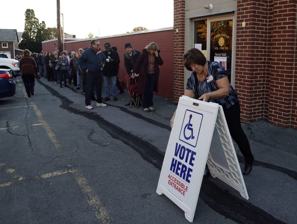 2016 Election Pennsylvania Voting An election official places a sign as voters line up outside a polling place November 2016 in Fogelsville, Pa. (AP Photo/Matt Slocum)