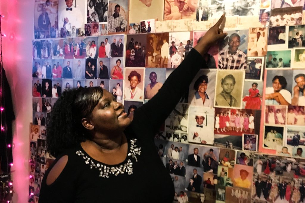 Shalonda Cooper shows pictures of her mother, Windora, before and after she got sick. She says the poor, segregated neighborhood she grew up in contributed to her mother's bad health. (Jake J. Smith)