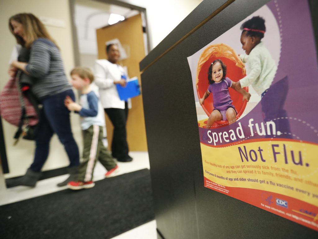 People 6 months and older should get vaccinated against the flu, says this government poster on display in a health center in Decatur, Ga. People 6 months and older should get vaccinated against the flu, says this government poster on display in a health center in Decatur, Ga