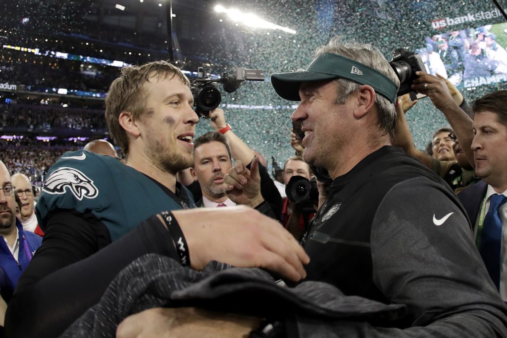 Philadelphia Eagles' Nick Foles celebrates with head coach Doug Pederson after winning Super Bowl LII against the New England Patriots .