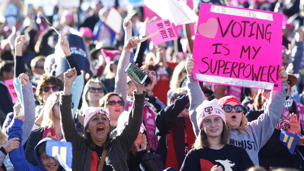 Attendees cheer a speaker during the Women’s March “Power to the Polls” voter registration tour launch at Sam Boyd Stadium on January 21, 2018, in Las Vegas, Nevada. Attendees cheer a speaker during the Women's March
