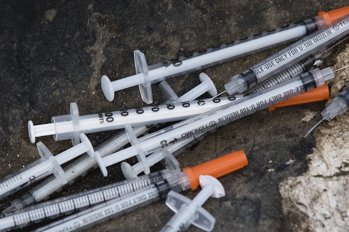 Opioid Epidemic Philadelphia FILE - This July 31, 2017, file photo shows discarded syringes in an open-air heroin market that has thrived for decades, slated for cleanup along train tracks a few miles outside the heart of Philadelphia. Philadelphia wants to become the first U.S. city to allow supervised drug injection sites as a way to combat the opioid epidemic, city officials announced Tuesday, Jan. 23, 2018, saying they would seek outside operators to establish one or more safe injection sites. (AP Photo/Matt Rourke, File)