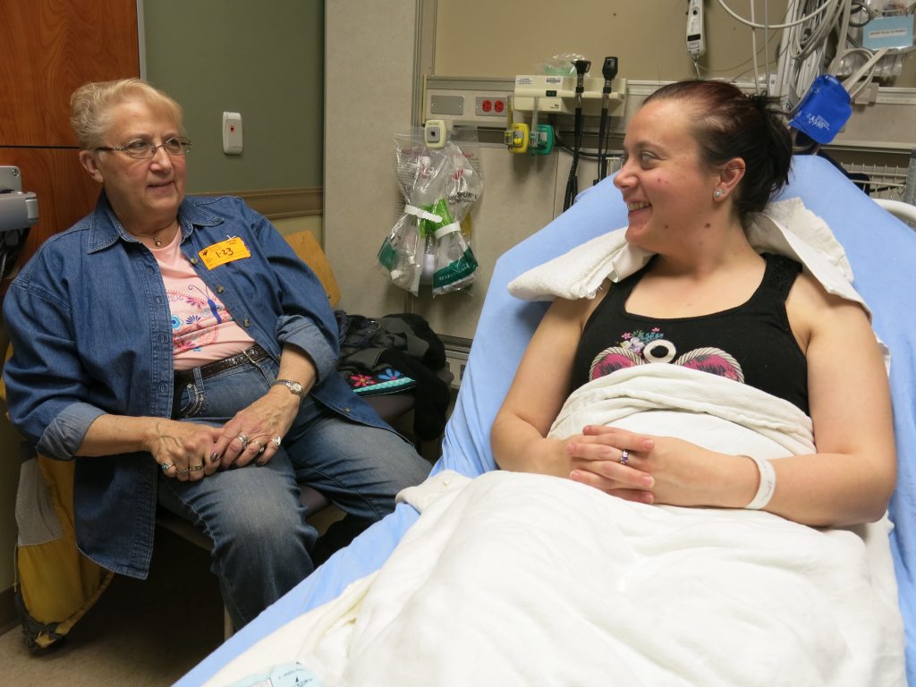 Ashley Copeland (right) talks to her mom Sue Iverson in the Swedish Medical Center emergency department, near Denver. Copeland got a nerve-blocking anesthetic instead of opioids to ease her severe headache. At discharge she was advised to use over-the-counter painkillers, if necessary. Ashley Copeland (right) talks to her mom Sue Iverson in the Swedish Medical Center emergency department, near Denver. Copeland got a nerve-blocking anesthetic instead of opioids to ease her severe headache. At discharge she was advised to use over-the-counter painkillers, if necessary.
(John Daley/CPR News)