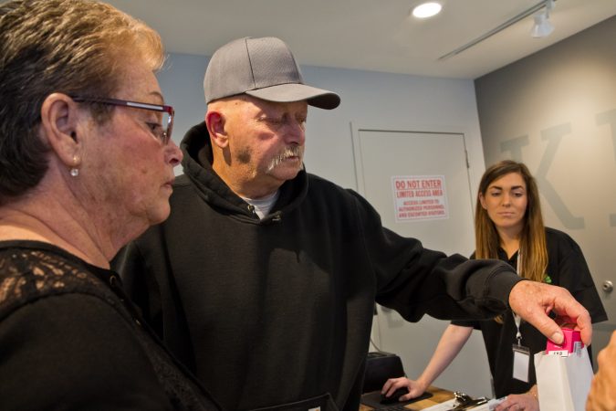 Cancer Patient Robert Brown and his sister Marion make the first purchase at The Keystone Shops. (Kimberly Paynter/WHYY)