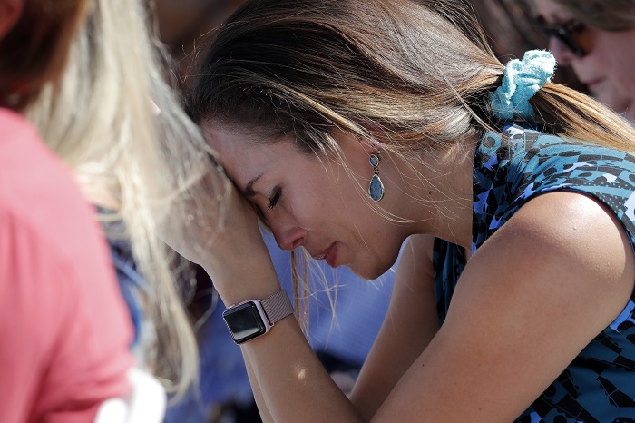 School Shooting Florida A woman cries as she bows her head in prayer during a vigil at the Parkland Baptist Church, for the victims of the Wednesday shooting at Marjory Stoneman Douglas High School, in Parkland, Fla., Thursday, Feb. 15, 2018. Nikolas Cruz, a former student, was charged with 17 counts of premeditated murder on Thursday. (AP Photo/Gerald Herbert)