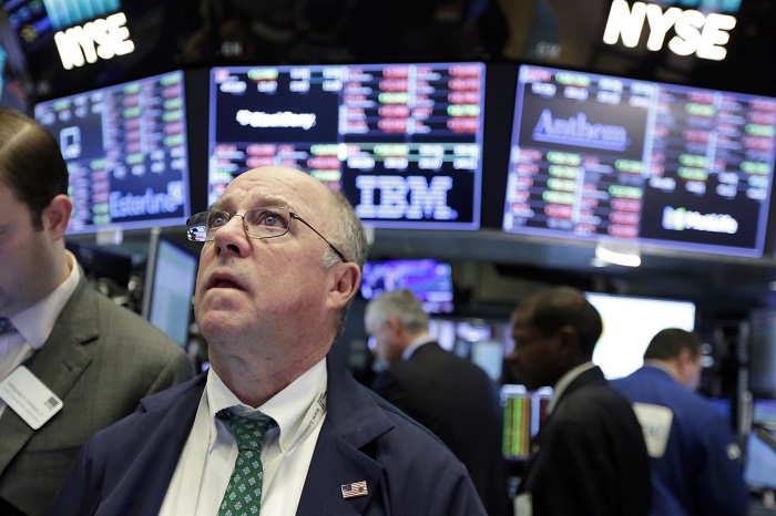 Trader Frederick Reimer works on the floor of the New York Stock Exchange, Tuesday, Feb. 6, 2018. The Dow Jones industrial average fell as much as 500 points in early trading, bringing the index down 10 percent from the record high it reached on Jan. 26. The DJIA quickly recovered much of that loss. (AP Photo/Richard Drew)