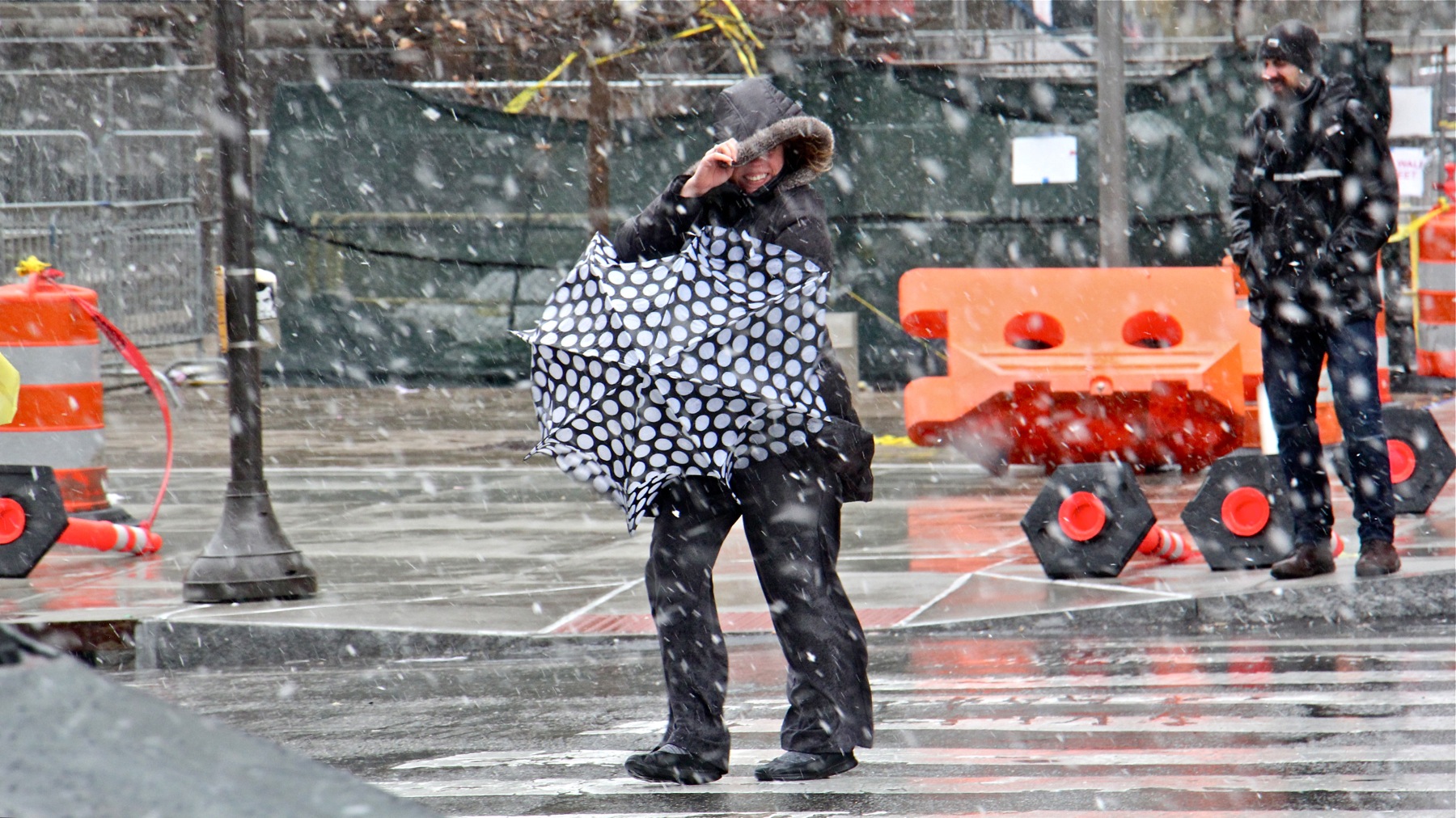 A pedestrian in Center City struggles against the strong winds and pelting snow.
