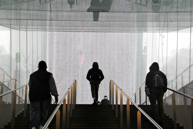 Travelers emerge from the Dilworth Park subway station into a wintry world. (Emma Lee/WHYY)