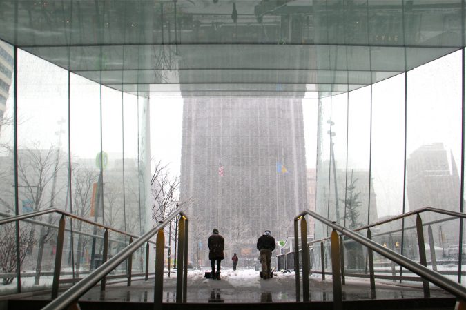 City workers clear the snow from the Dilworth Park subway entrance. (Emma Lee/WHYY)