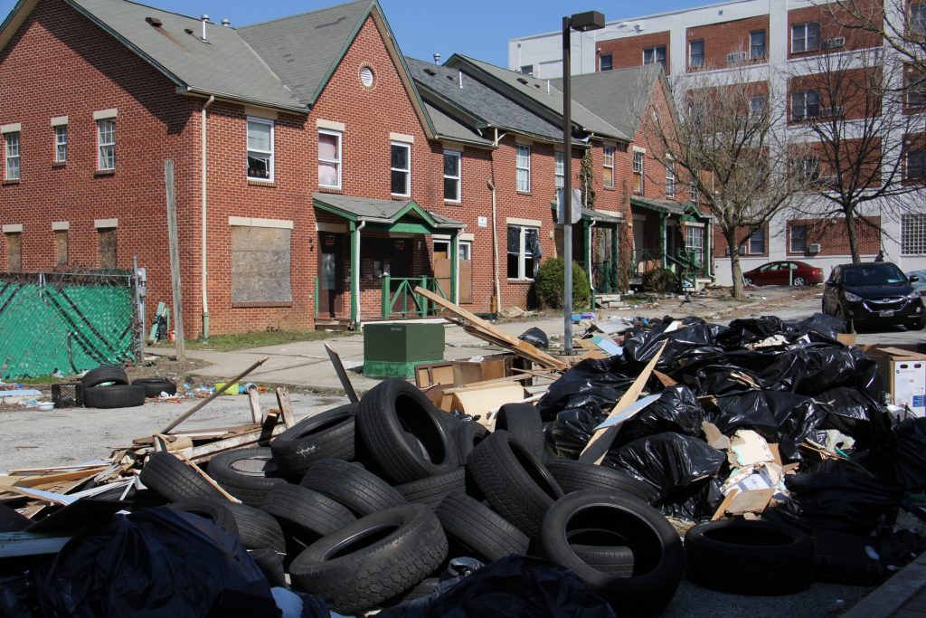 2018 03 15-e lee-philadelphia germantown-developer emanuel freeman Garbage is piled in front of an apartment complex in Lower Germantown. (Emma Lee/WHYY)