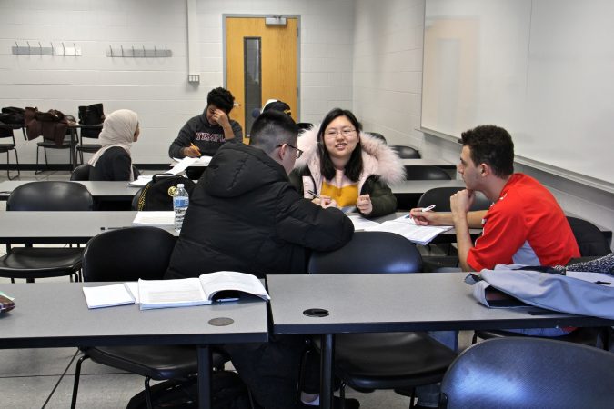 Students split into small discussion groups during an intensive Englisht course for international students at Temple University. (Emma Lee/WHYY)