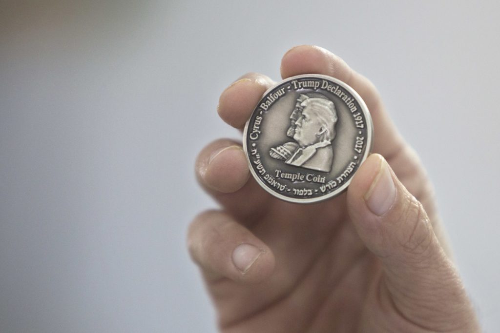 Jerusalem Trump Coin Head of the Mikdash Educational Center, Rabbi Mordecahi Persoss, holds a coin they minted bearing President Donald Trump's image to honor his recognition of Jerusalem as Israel's capital, in Tel Aviv, Israel, Wednesday, Feb. 28, 2018. The center said Wednesday that the