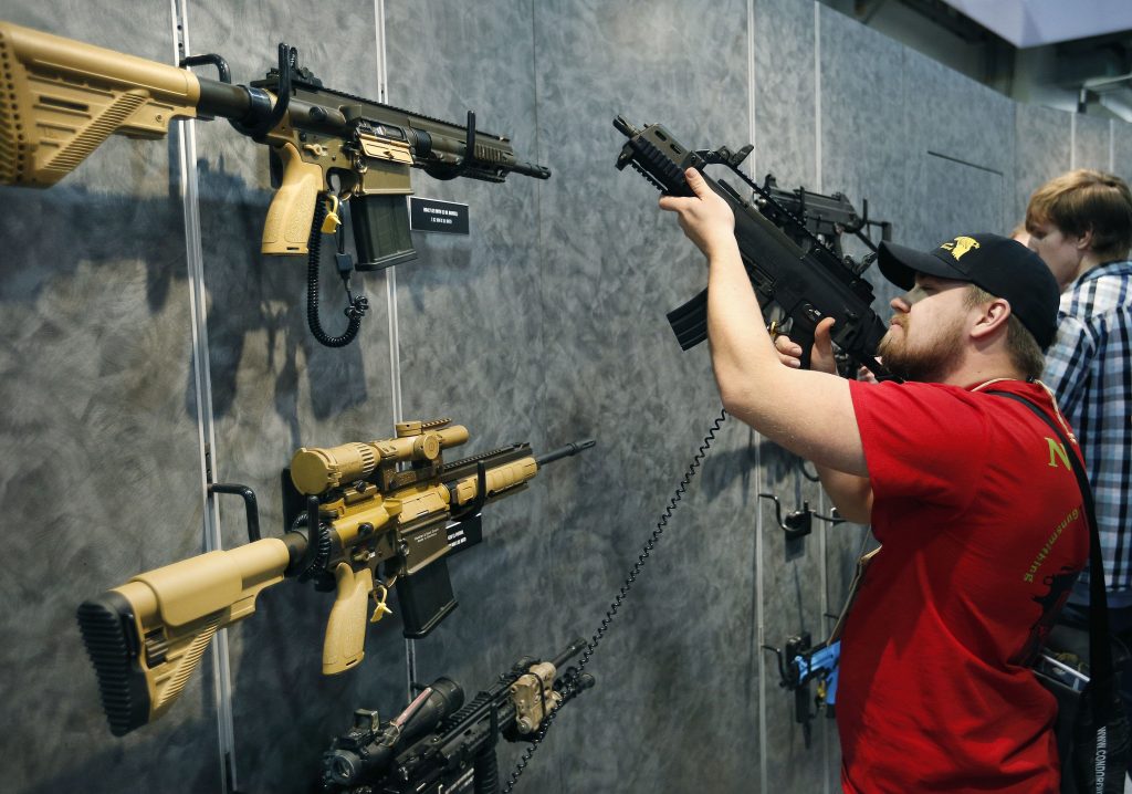 AP Poll Guns (AP Photo/John Locher)