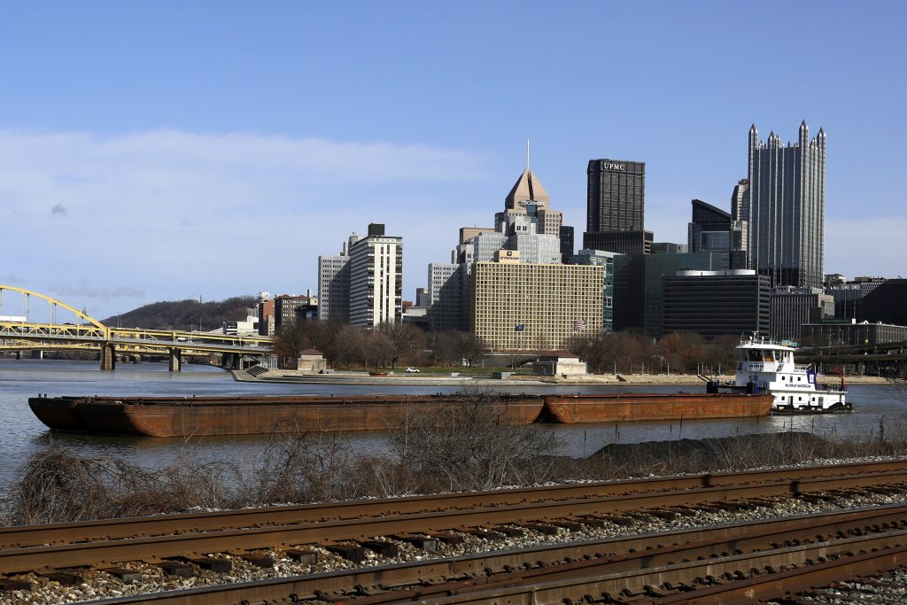 A towboat pushes barges on the Monongahela river past the skyline of downtown Pittsburgh, March 1, 2017. (AP Photo/Gene J. Puskar)