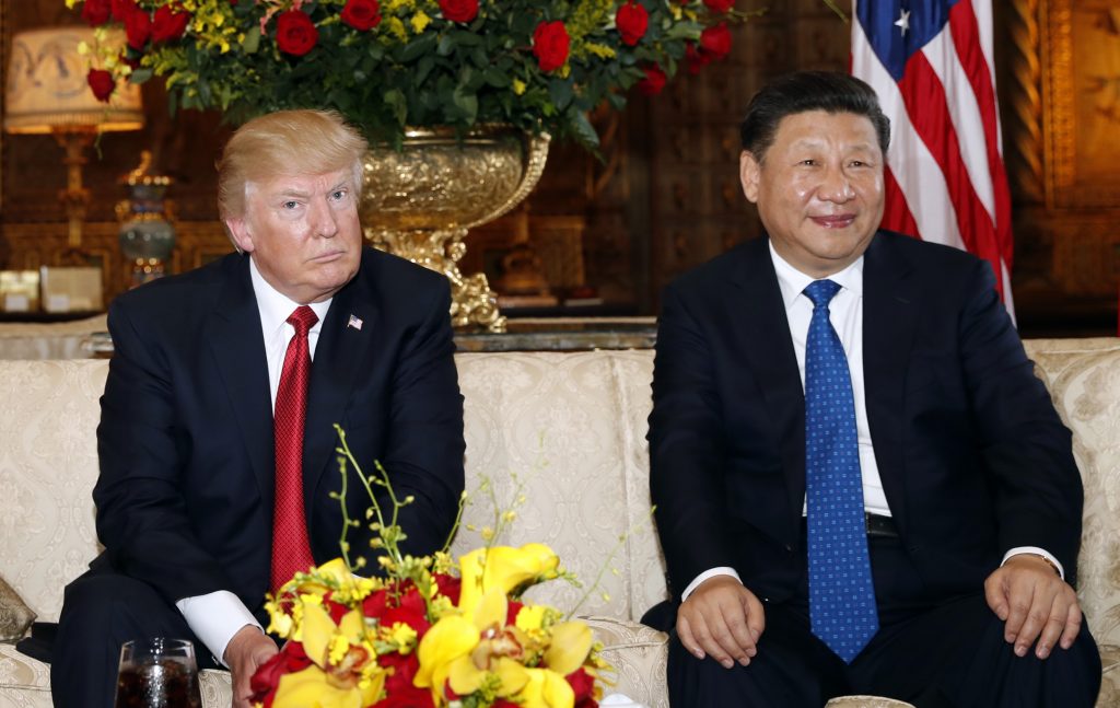 Donald Trump, Xi Jinping President Donald Trump and Chinese President Xi Jinping, sit as they pose for photographers before a meeting at Mar-a-Lago, Thursday, April 6, 2017, in Palm Beach, Fla.