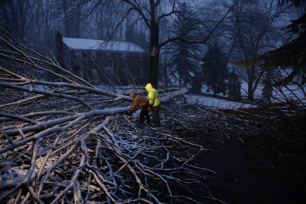 APTOPIX Coastal Storm Pennsylvania Streets department workers David Boardly, left, and James Ockimey clear a downed tree during a winter storm, Friday, March 2, 2018, in Marple Township, Pa.